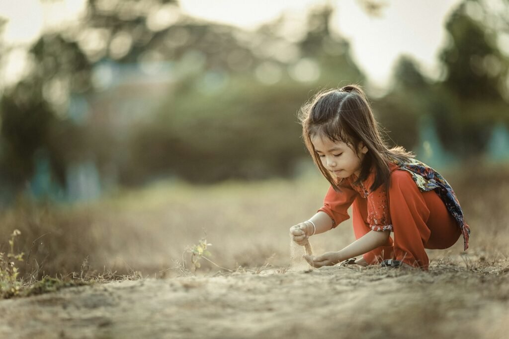 A child exploring outdoors in warm afternoon light